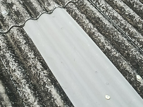 福山市の北部にてヒビや割れのある大波スレート屋根の補修工事割れたスレートの交換